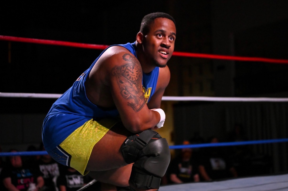Isaiah Legend crouched in the corner of the ring